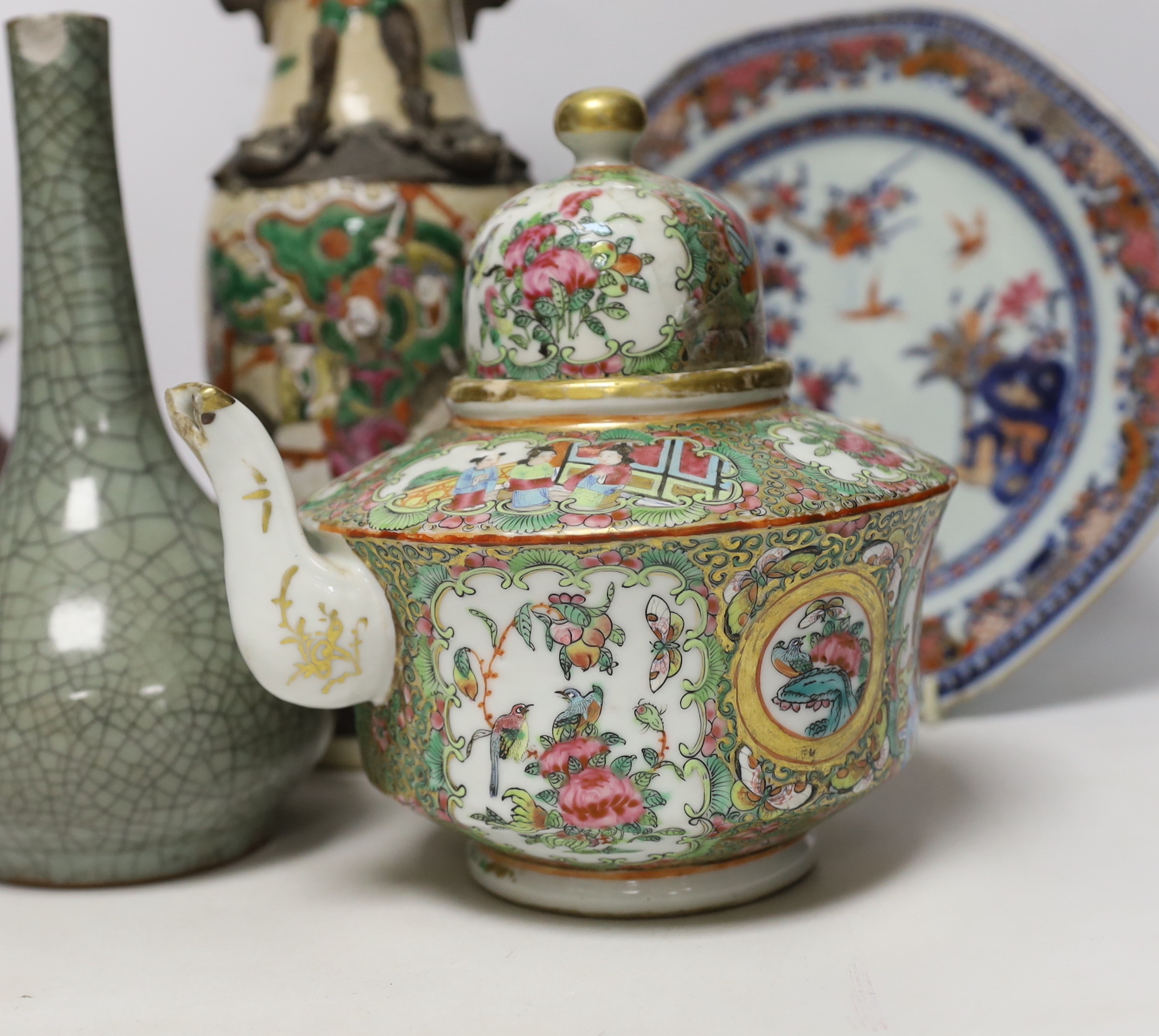 An 18th century Chinese export dish, a sang de boeuf squat vase, a crackle glaze bottle vase and a famille rose teapot, tallest 23cm